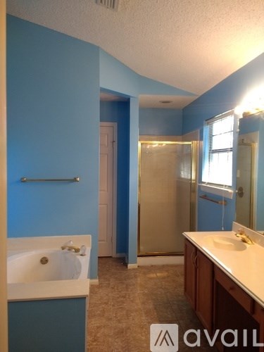 A bathroom with blue walls and a white sink.