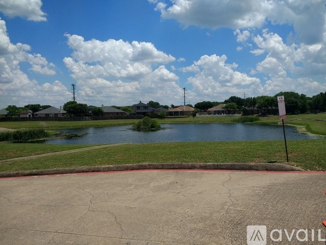 A view of a lake from a parking lot.