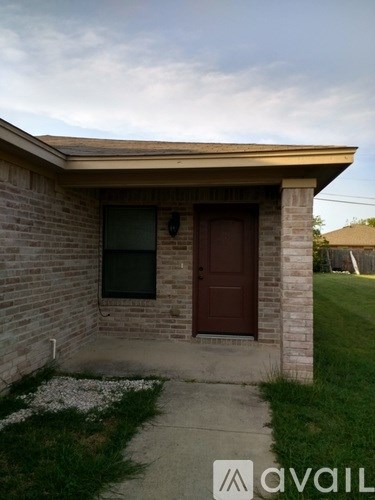 A small house with a brown door and a window.