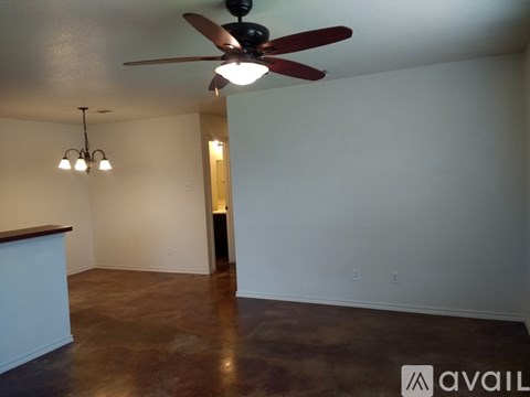 A room with a ceiling fan and a chandelier.