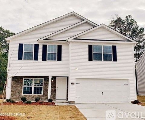 A two-story house with a white garage door.