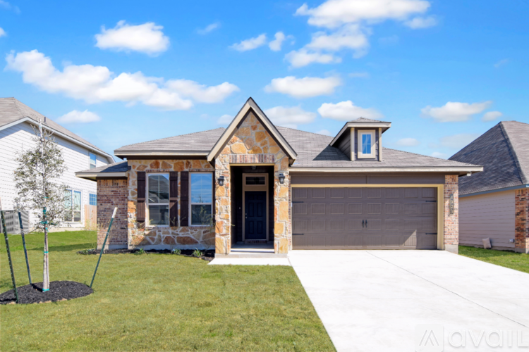 A house with a garage and a driveway in front.