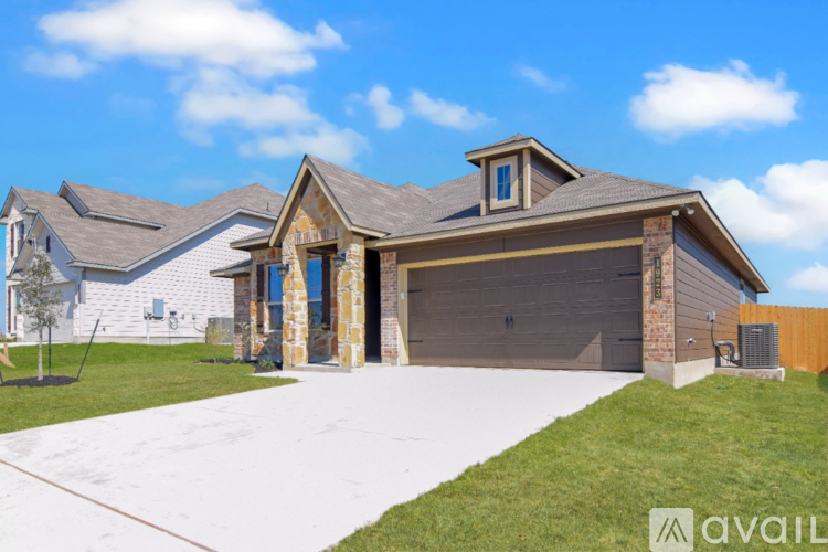 A house with a garage and a driveway in front.