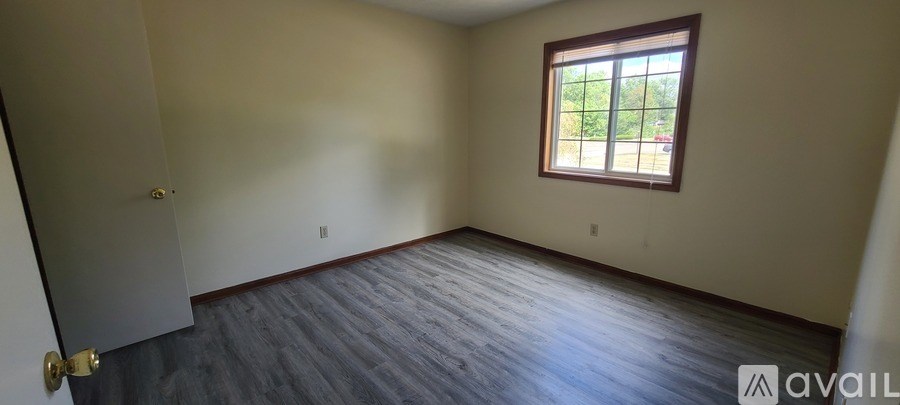 A kitchen with a sink and wooden floor.