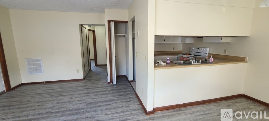 A kitchen with white cabinets and a white fridge.