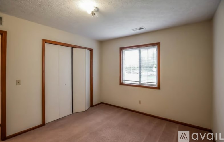 A room with a window and a sliding door.