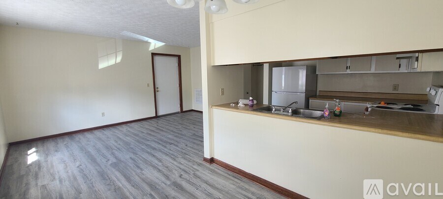 A white bathroom with a toilet, sink, and bathtub.