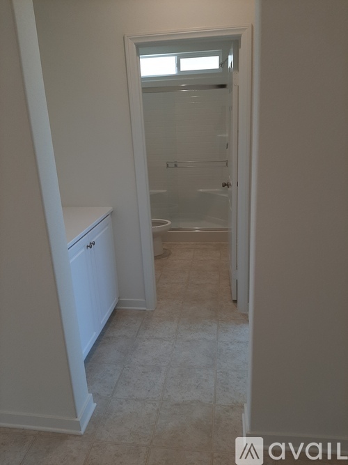 A bathroom with a toilet and a walk-in shower.