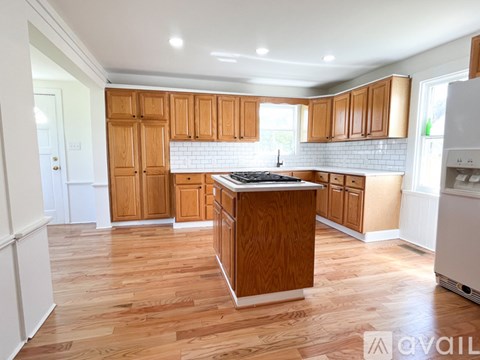 A kitchen with wooden cabinets and a white refrigerator.
