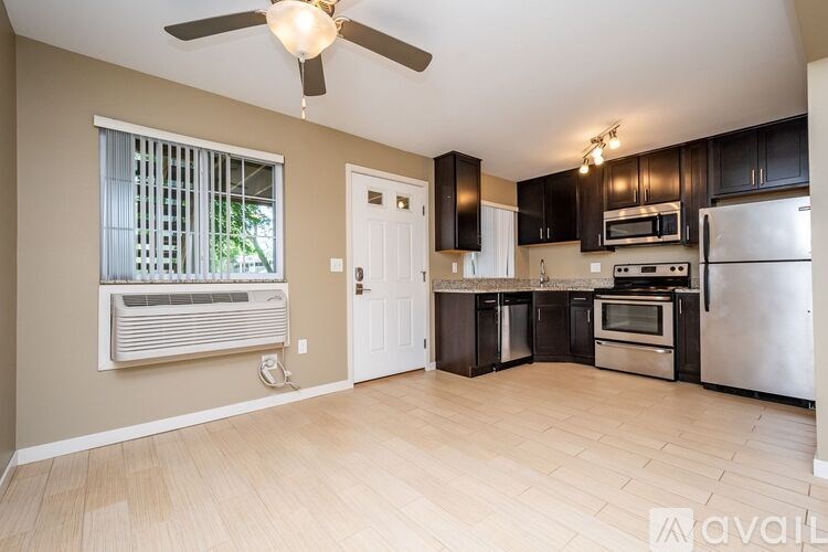 A kitchen with a refrigerator, oven, and microwave.