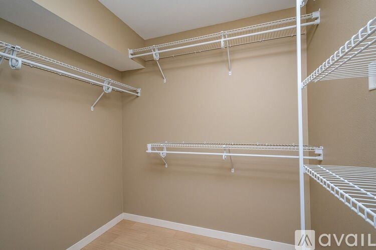 A room with a white metal rack system installed on the wall.