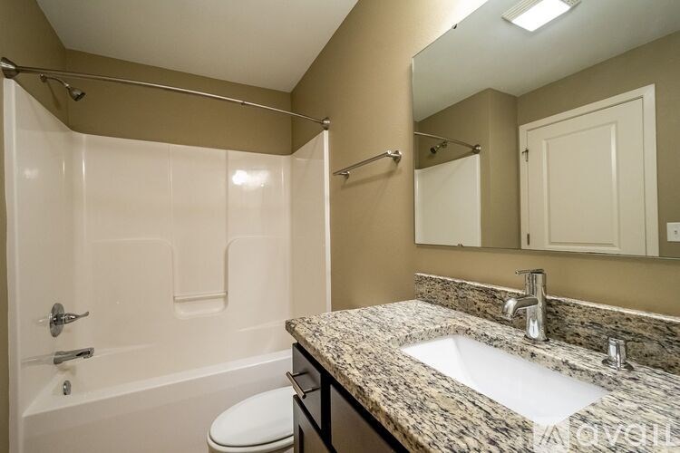 A bathroom with a sink, toilet, and bathtub.