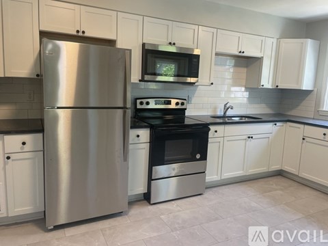A kitchen with a stainless steel refrigerator and oven.