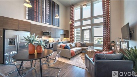 A living room with a black table and a couch.