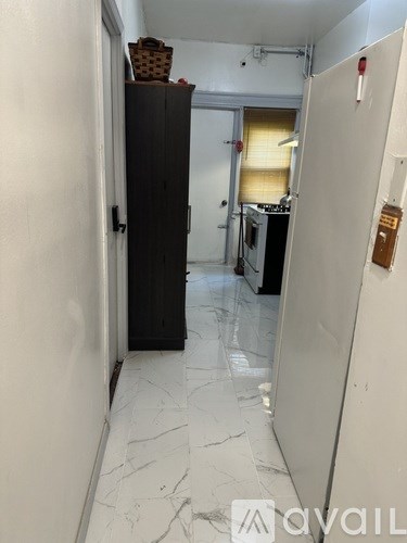 A kitchen with a black cabinet and a white fridge.