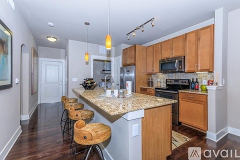 A kitchen with wooden cabinets and a granite countertop.