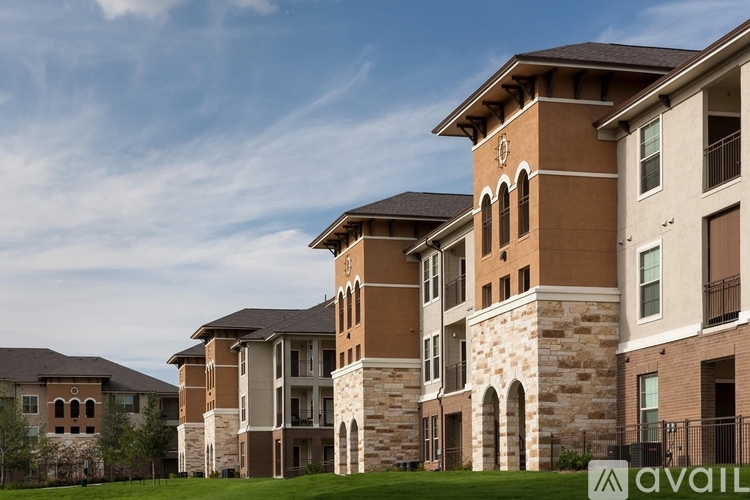A row of apartment buildings with a sign that says "available" in front of them.