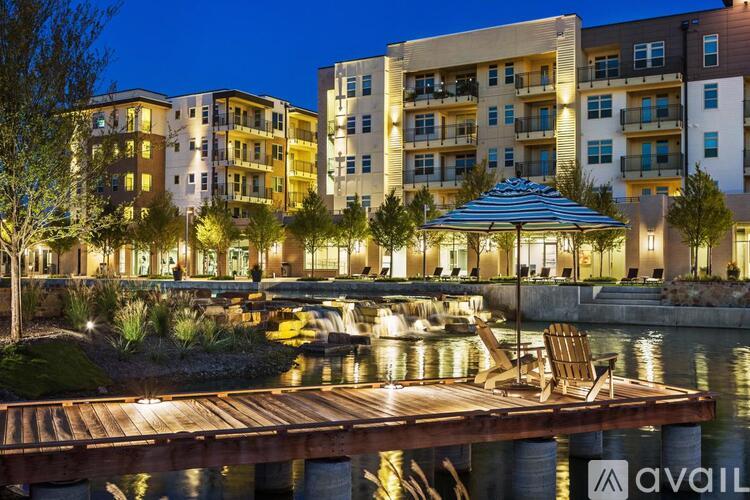 A modern apartment complex with a water feature in the foreground.