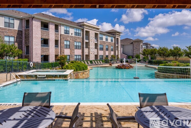 A pool area with chairs and a building in the background.