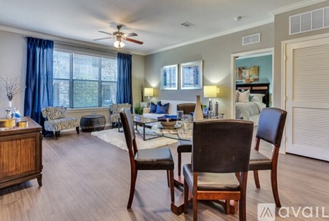 A living room with a dining table and chairs.