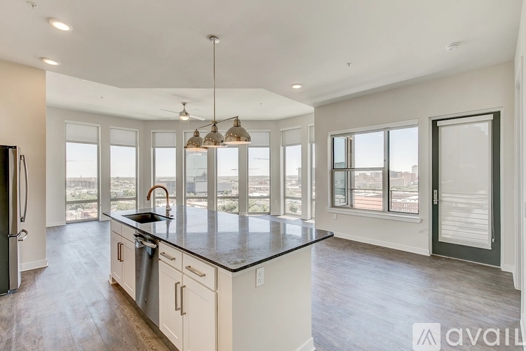 A kitchen with a large island and a view of the city.