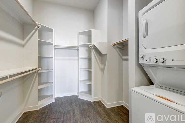 A white oven is in a kitchen with white cabinets.