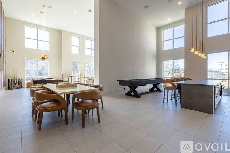 A modern dining room with a large table and chairs.