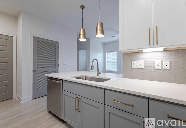 A modern kitchen with a sink and cabinets.