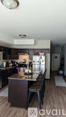 A kitchen with a table and chairs in the middle.