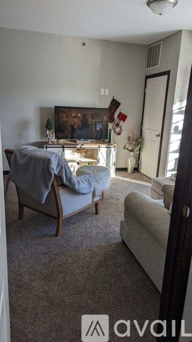 A living room with a couch and a chair.