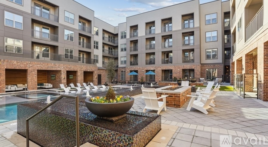 A large outdoor pool area with a bowl of flowers in the middle.