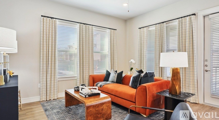 A living room with a sofa, a coffee table, and a lamp.