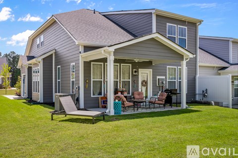A house with a family sitting on the porch.