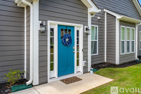 A house with a blue door and a wreath on it.