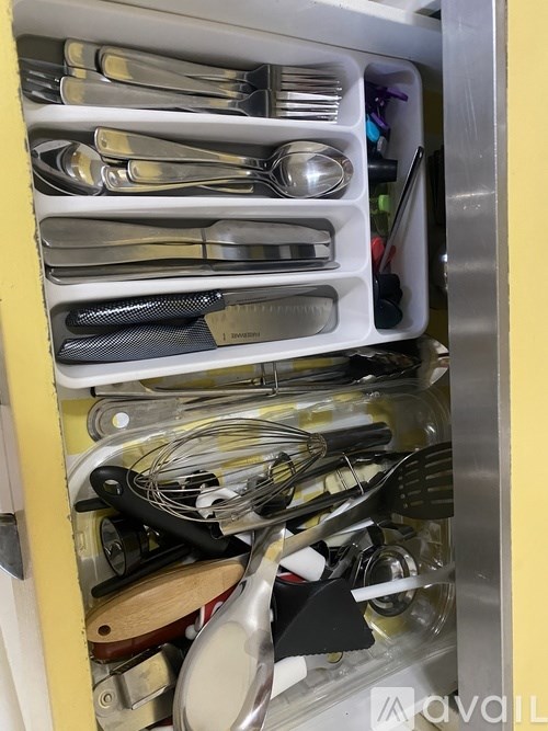 A drawer full of silverware and utensils.