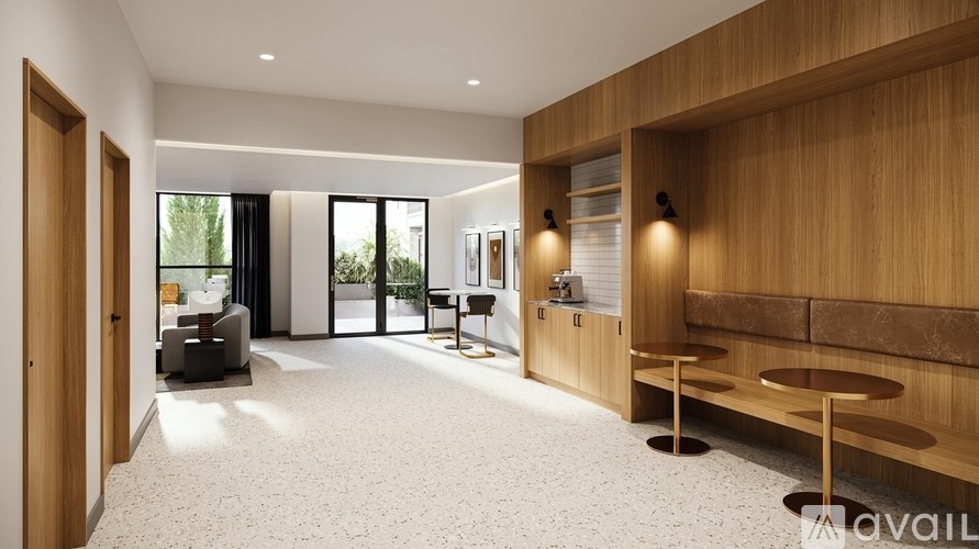 A modern living room with a wooden accent wall and a seating area.