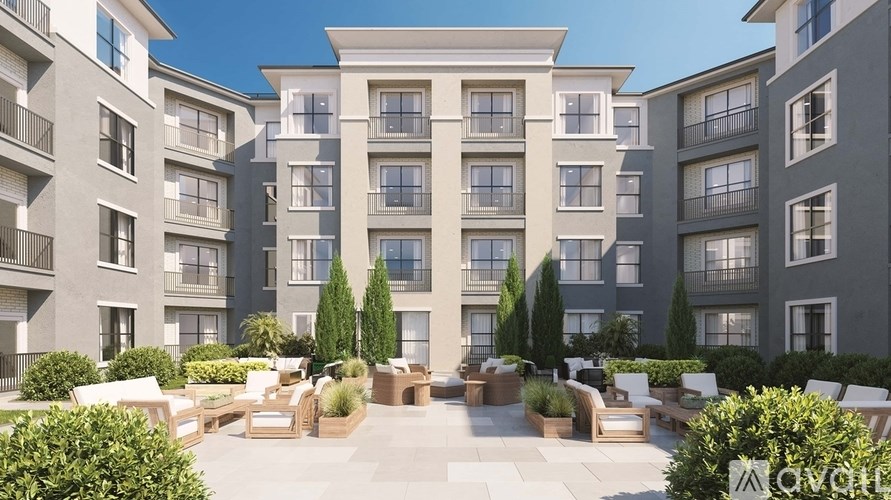 A modern apartment complex with a central courtyard and seating area.