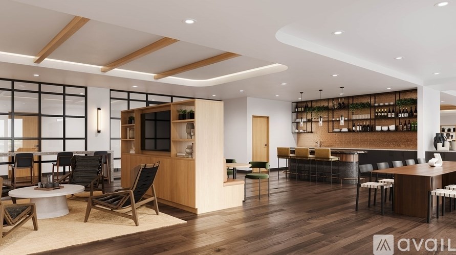 A modern living room with a bar area and a dining table.