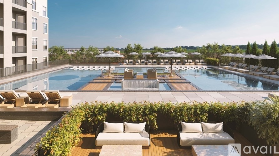 A large outdoor pool area with sun loungers and umbrellas.