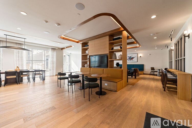 A modern living room with a wooden floor and furniture.