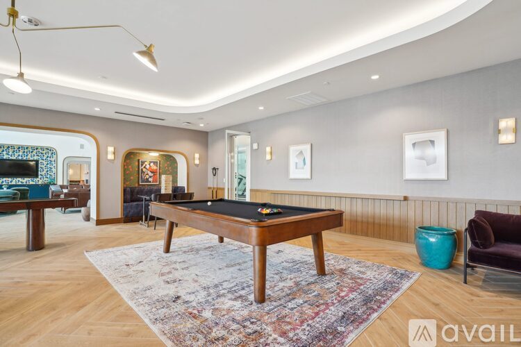A room with a pool table and a couch.