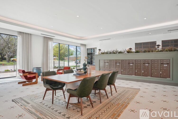 A modern dining room with a large table and chairs.