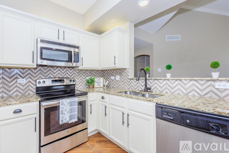 A kitchen with a stove top oven and a microwave above it.