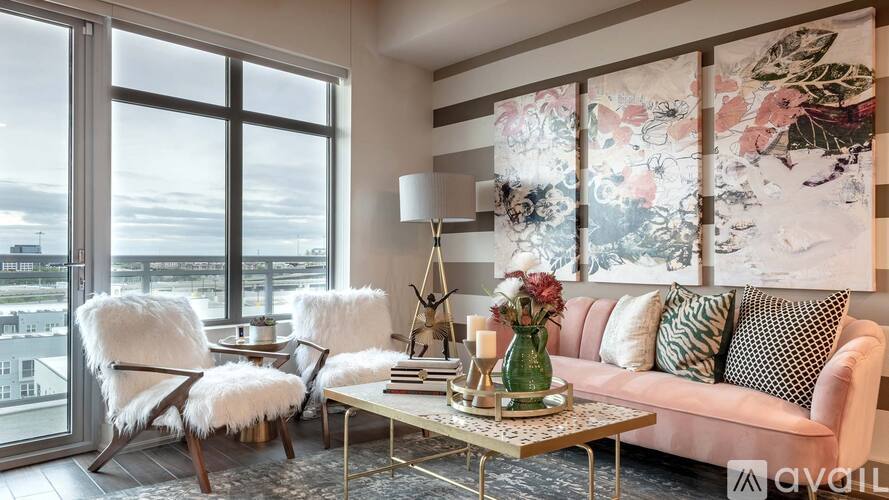 A living room with a couch, chairs, and a coffee table.