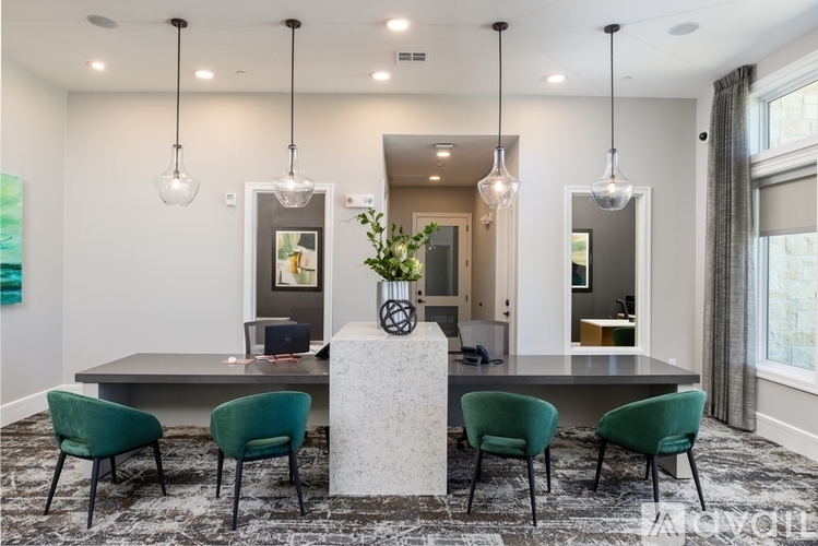 A modern dining room with a black table and green chairs.