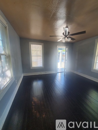 A room with wooden floors and a ceiling fan.