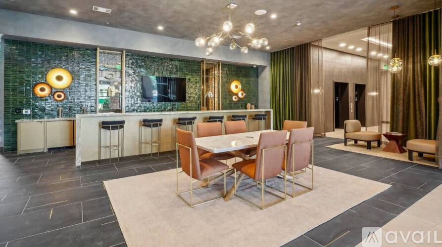 A modern dining room with a glass table and chairs.