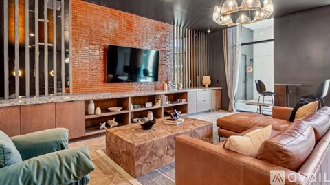 A living room with a brown leather couch and a wooden coffee table.