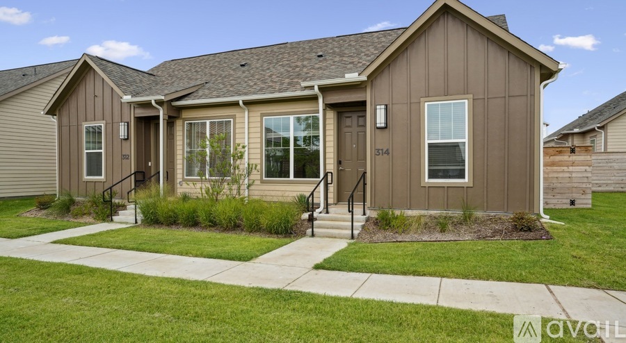 A house with a brown exterior and a white door is numbered 514.