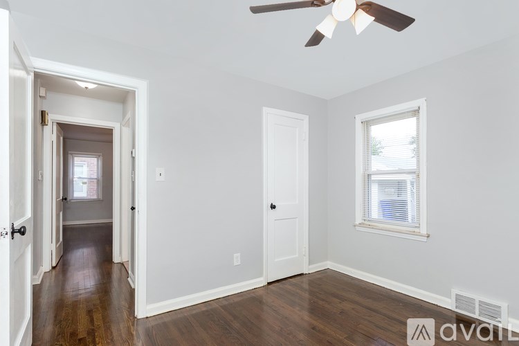 A room with a ceiling fan and a window.